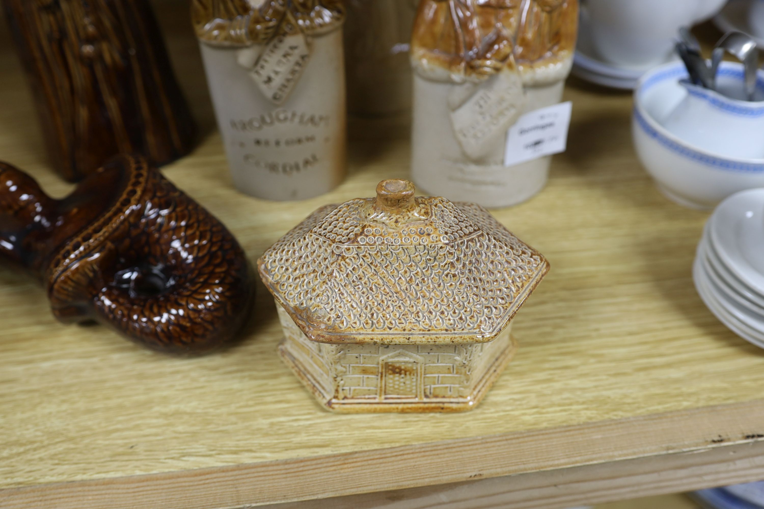 A collection of five salt glazed stoneware gin flasks, including:- 'Lord Brougham - The True Spirit of Reform', reproduction 'The Second Magna Carta - Brougham Reform Cordial' 'Mr & Mrs Caudle', two other flasks and a De
